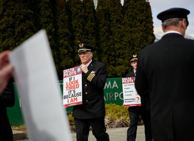 Off-duty Delta Air Lines pilots protest against scheduling practices and long hours outside Seattle-Tacoma International Airport in Washington.  Reuters