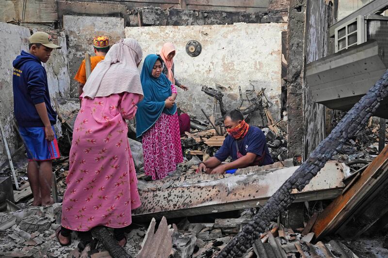 Residents assess the damage done to their homes. The government has said it will cover the medical expenses of those injured. AP