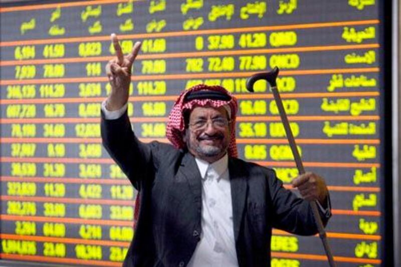 An investor celebrates after the Qatari stock market went up 5.32 percent at its close, at Doha Securities Market in Doha in this December 2, 2009 file photo. Looking beyond the shock of Dubai's debt crisis, investors in the world's top oil exporting region see some of the most compelling stories globally, especially in Saudi Arabia and Qatar whose benchmark indexes surged early in the year.    To match Feature FRONTIERS/GULF      REUTERS/ Fadi Al-Assaad/Files  (QATAR - Tags: BUSINESS)