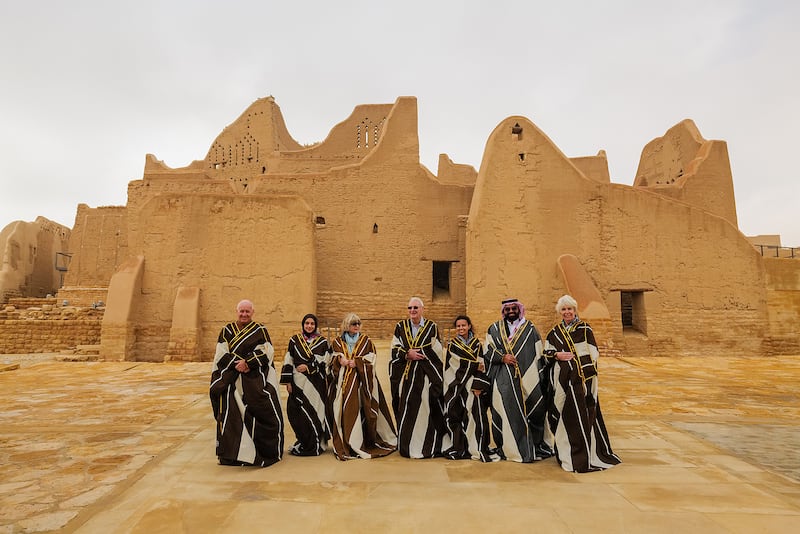 Mr Evans, left, with Sara Philby, Mandy Oates, Michael Engelbach and his wife, Reem Philby and Sami Alotaibi in the historic At-Turaif District