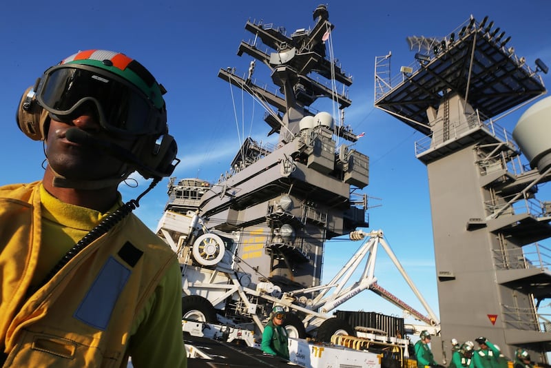 AT SEA - JANUARY 18: A U.S. Navy catapult officer (L) works on the flight deck of the USS Nimitz (CVN 68) aircraft carrier while at sea on January 18, 2020 off the coast of Baja California, Mexico. The USS Nimitz is currently conducting routine operations and training at sea. The nuclear-powered aircraft carrier holds a flight deck area of 4.5 acres and can hold 65 aircraft along with nearly 5,000 total personnel. It is the oldest U.S. Navy carrier in active service and was commissioned on May 3, 1975.   Mario Tama/Getty Images/AFP