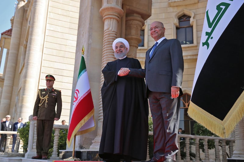 Iraqi President Barham Salih (R) shakes hands with his Iranian counterpart Hassan Rouhani upon his arrival at the Presidential palace in Baghdad on March 11, 2019. Iran's President Hassan Rouhani arrived in Iraq for his first official visit, as Baghdad comes under pressure from Washington to limit political and trade ties with its neighbour. / AFP / SABAH ARAR
