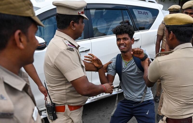 Police detain a protester in Chennai.