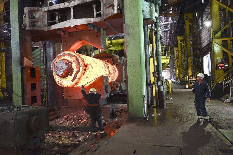 A forgeman oversees the manipulation of a 100 tonne cylinder of of freshly cast hot steel. Oli Scarff / AFP