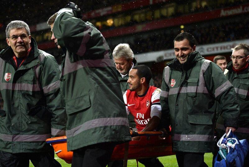 Theo Walcott will miss six months after injuring his left knee against Tottenham, Arsenal announced on Monday. Dylan Martinez / Reuters