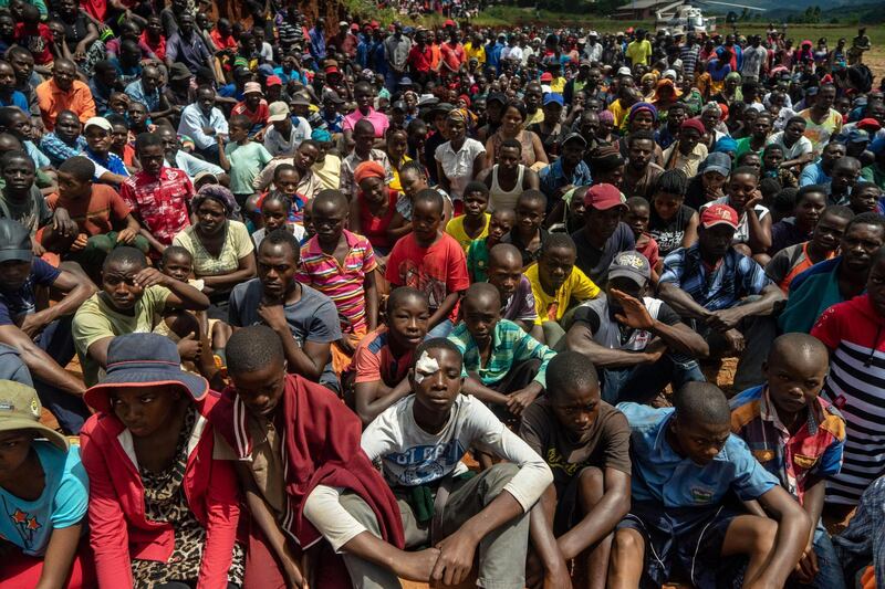 Survivors listen to Zimbabwe's President Emmerson Mnangagwa addressing residents of Ngangu, a township of Chimanimani during his tour of the affected areas. AFP