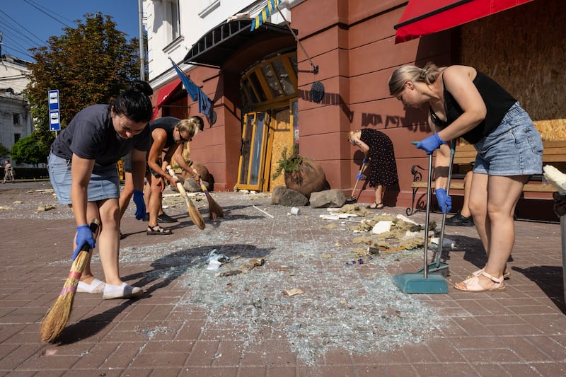 Residents of Chernihiv clean up debris after the Russian missile attack in the city centre. Ukrainian President Volodymyr Zelenskyy has promised a 'notable response' to the strike.