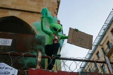 A protester dressed in an alien costume takes part in a demonstration against Lebanon's government in downtown Beirut. AFP