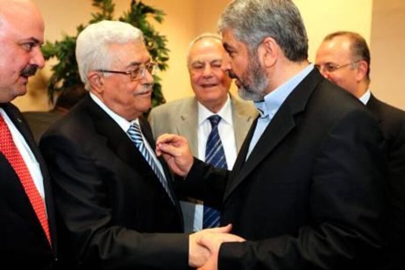 EDITOR'S NOTE: RESTRICTED TO EDITORIAL USE - MANDATORY CREDIT "AFP PHOTO / HO / HAMAS PRESS OFFICE" - NO MARKETING NO ADVERTISING CAMPAIGNS - DISTRIBUTED AS A SERVICE TO CLIENTS
A handout picture released by the Hamas Press Office shows Palestinian president Mahmud Abbas (L) shaking hands with Hamas leader Khaled Meshaal (R) in Cairo on May 4, 2011 during a reconciliation ceremony that ended a nearly four-year feud but has angered Israel. AFP PHOTO/HO/HAMAS PRESS OFFICE
 *** Local Caption ***  920738-01-08.jpg