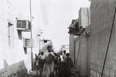 Drummer Khamees Abu Tubaila and his entourage walk the alleyways of Abu Dhabi to wake people and prepare them for the day’s fasting. Courtesy Alettihad