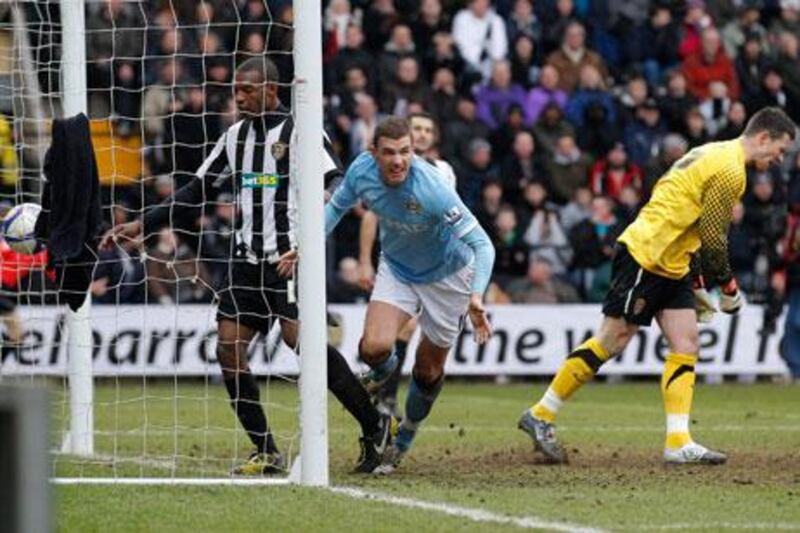 Manchester City’s Edin Dzeko, right, celebrates his equaliser yesterday – his first goal for the club.