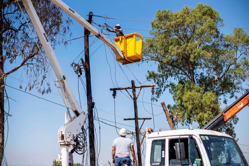 Eskom employees dismantle an illegal electricity substation during an operation conducted by South African electricity public utility Eskom to remove illegal connections in Diepsloot, Johannesburg, on September 29, 2020. / AFP / Michele Spatari
