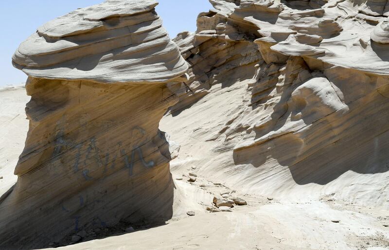 Abu Dhabi, United Arab Emirates - Graffiti vandalism near the entrance of the ancient rock formations attraction in the outskirts desert area, at Al Wathba. Khushnum Bhandari for The National