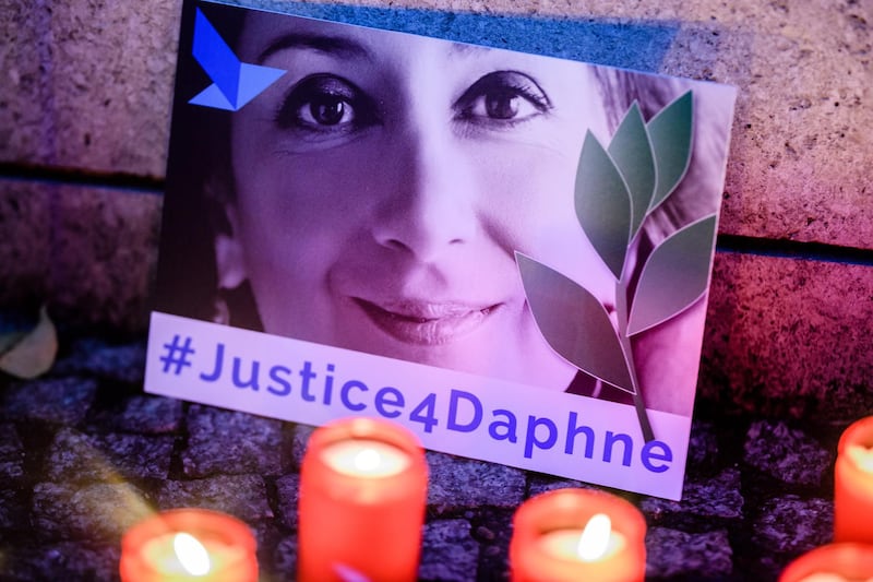 'Justice 4 Daphne' is written on a card showing an image of Daphne Caruana Galizia during a picket for the murdered journalist in front of the Maltese embassy in Berlin, Germany, on October 16, 2019.