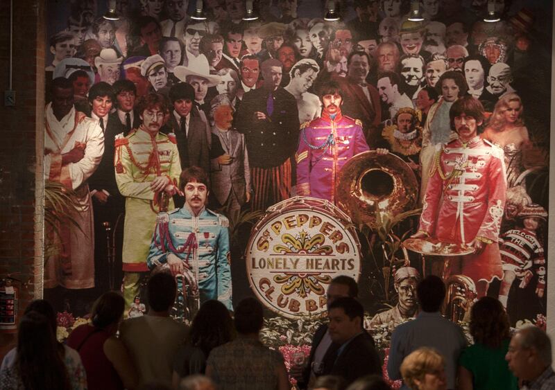 Visitors enjoy British photographer Michael Cooper's exhibition on The Beatles' Sgt Pepper Lonely Hearts Club band  in Monterrey Nuevo Leon, Mexico. Julio Cesar Aguilar / AFP Photo