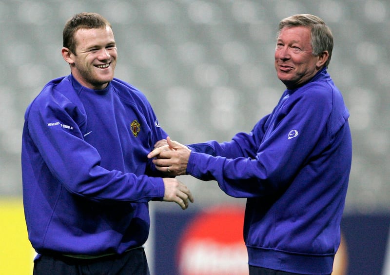 Manchester United's Wayne Rooney jokes with his manager Alex Ferguson during a training session at the Stade de France stadium, outside Paris on November 1, 2005. AP