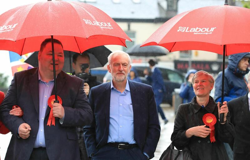 Labour Party leader Jeremy Corbyn, center, arrives Friday May 3, 2019 to celebrate the election result for Trafford Council with Labour Party activists at the Waterside Arts Centre, Manchester, England, following the voting in Thursday's English council elections. (Peter Byrne/PA via AP)
