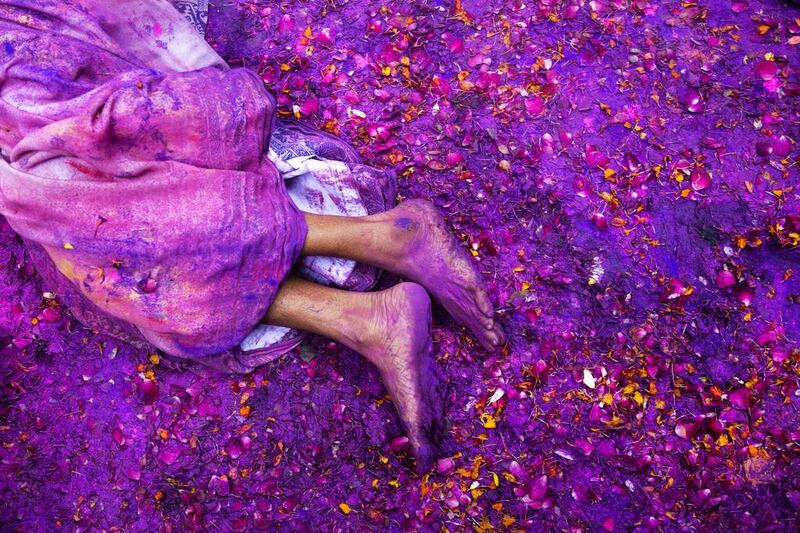 A Hindu widow lies on a sludgy ground filled with a mixture of coloured powder, water and flower petals during celebrations to mark Holi at the Meera Sahabhagini Widow Ashram in Vrindavan, India on March 3. Bernat Armangue / AP Photo