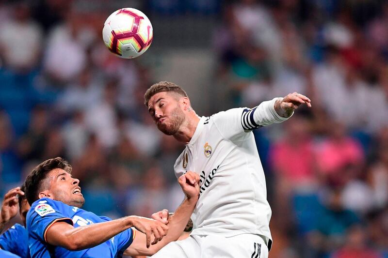 Real Madrid's Spanish defender Sergio Ramos (R) heads the ball with Getafe's Uruguayan defender Leandro Cabrera during the Spanish League football match between Real Madrid and Getafe at the Santiago Bernabeu stadium in Madrid on August 19, 2018. (Photo by JAVIER SORIANO / AFP)