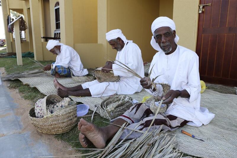 Men make traditional woven handicrafts at the Sheikh Zayed Heritage Festival. Sarah Dea / The National
