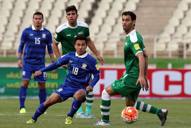 Thailand's Chanathip Songkrasin (18) passes the ball past Iraq's Saad Abdul-Amir, right, during a qualifying match in March. Atta Kenare / AFP