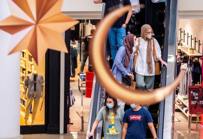 Shoppers walk under ceiling decorations at Al Wahda Mall. Victor Besa / The National