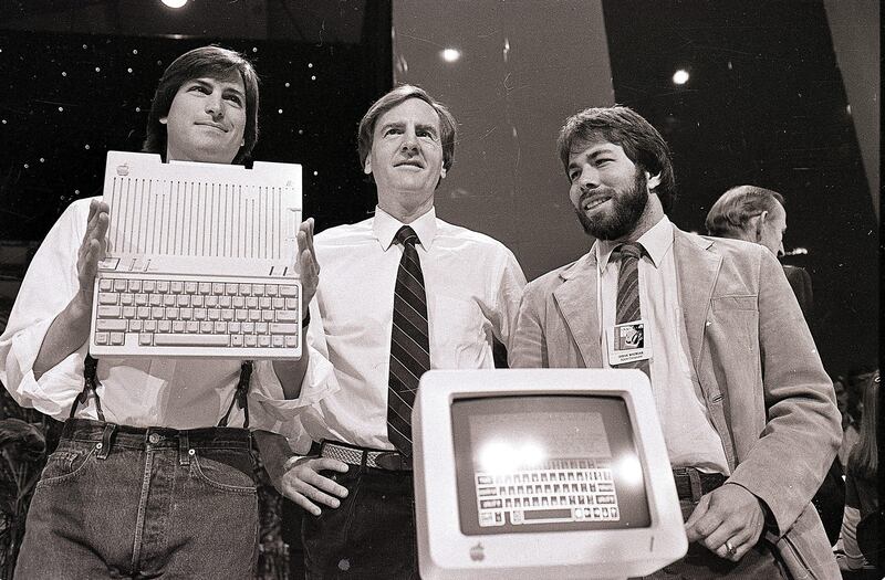 FILE - In this April 24, 1984, file photo, from left, Steve Jobs, chairman of Apple Computers, John Sculley, president and CEO, and Steve Wozniak, co-founder of Apple, unveil the new Apple IIc computer in San Francisco. Apple on Wednesday, Oct. 5, 2011 said Jobs has died. He was 56. (AP Photo/Sal Veder, File) *** Local Caption ***  Obit Steve Jobs.JPEG-0e0aa.jpg