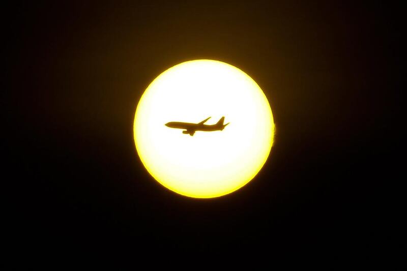 An airliner passes in front of the sun at dawn in Bogota. Felipe Caicedo / AFP