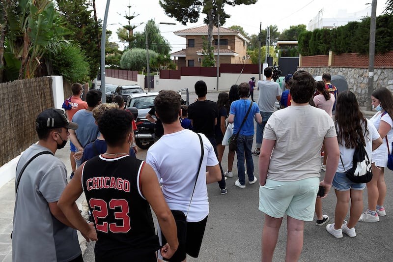 Fans gather outside the home of Barcelona forward Lionel Messi in Barcelona on August 9, 2021.
