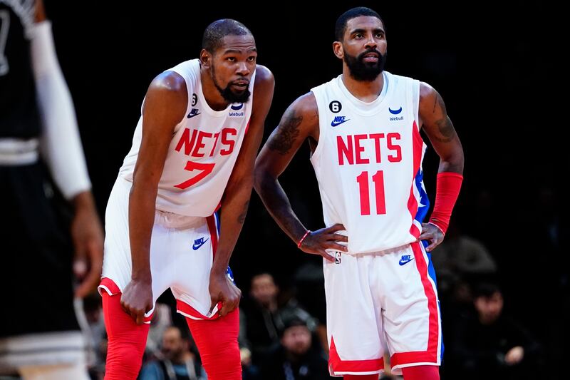 Brooklyn Nets' Kevin Durant, left, talks to Kyrie Irving during the game against the San Antonio Spurs. AP