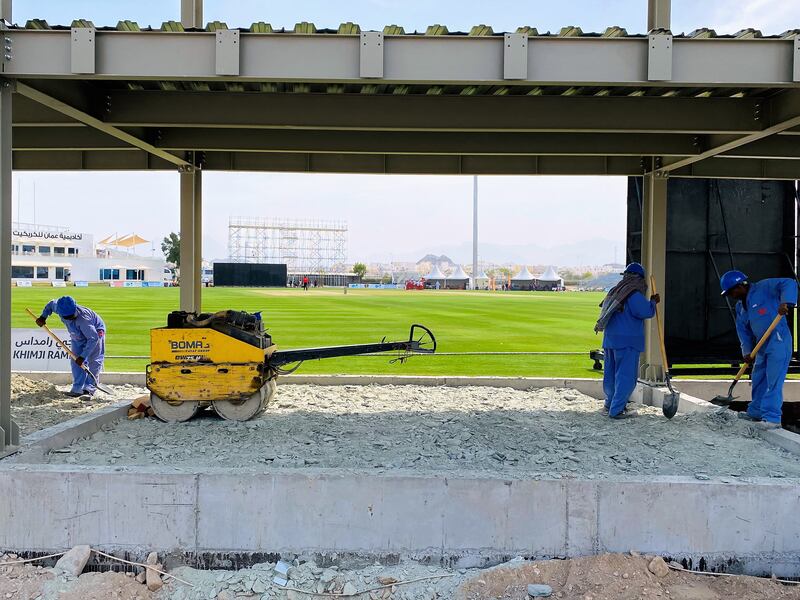 Workers on duty at the Oman Cricket Academy ground in Al Amerat. Paul Radley / The National