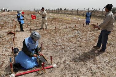 People clear landmines in Basra, Iraq. Reuters
