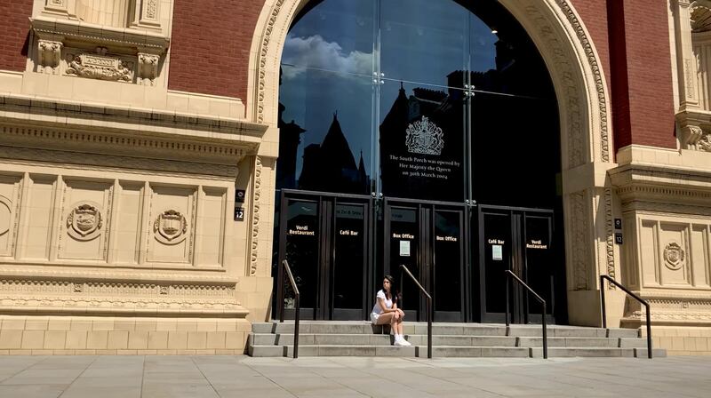 Royal Ballet dancer Yasmine Naghdi sits outside the entrance of London's Royal Albert Hall. Reuters