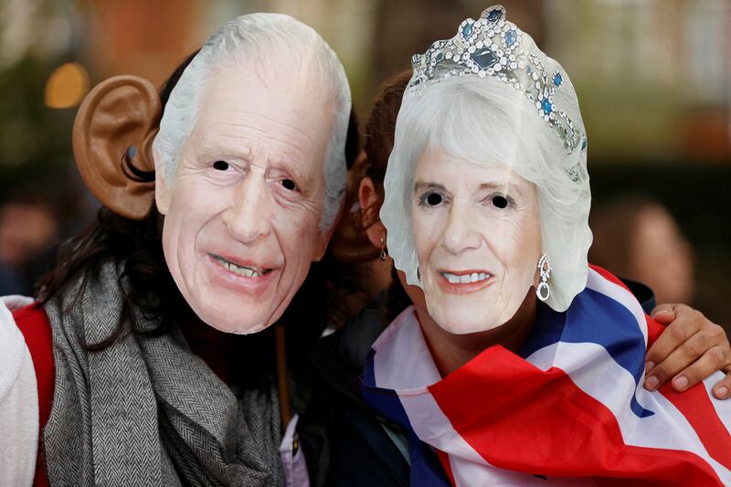 Masks of King Charles III and Queen Consort Camilla on show for coronation day in London. Reuters