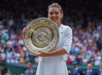 FILE PHOTO: Jul 13, 2019; London, United Kingdom; Simona Halep (ROU) poses with her trophy after defeating Serena Williams (USA) in the women's singles final on day 12 at the All England Lawn and Croquet Club. Mandatory Credit: Susan Mullane-USA TODAY Sports/File Photo