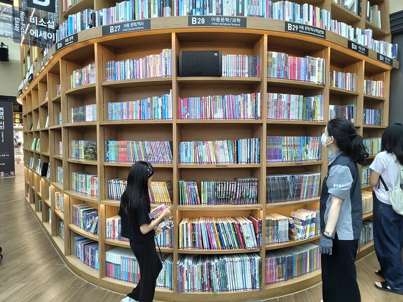 Visitors peruse the bookshelves at Seoul's Starfield Library.