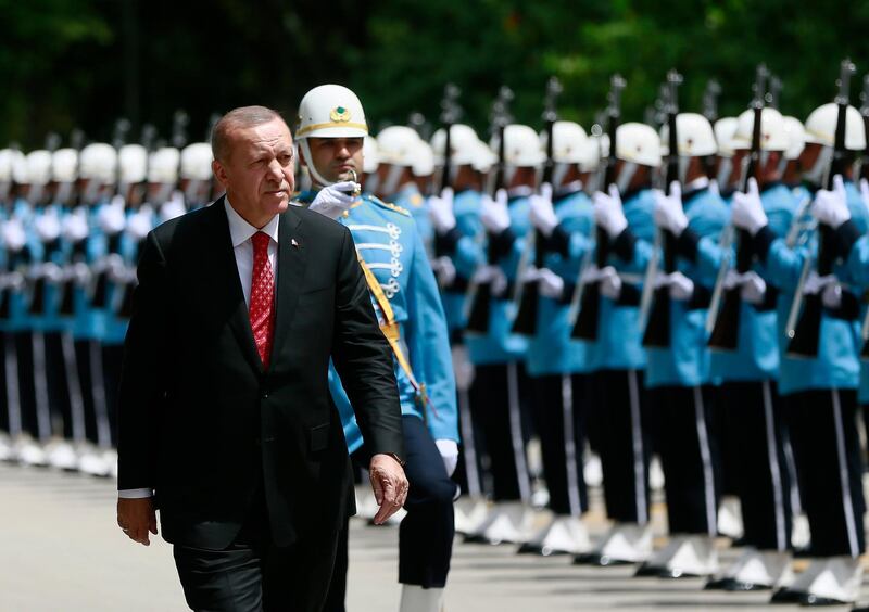 Turkey's President Recep Tayyip Erdogan inspects honour guard as he arrives for a special session of the Parliament, in Ankara, Turkey, Monday, July 15, 2019. Turkey is marking the third anniversary of the July 15 failed coup attempt against the government, with prayers and other events remembering its victims.(Presidential Press Service via AP, Pool)