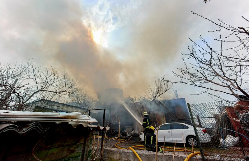 Ukrainian rescuers try to put out the fire at a private building after shelling in Kharkiv, Ukraine. EPA