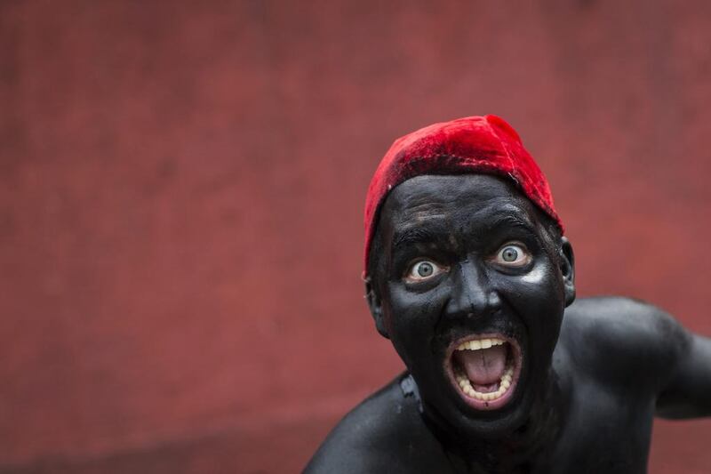 A reveler dressed as Brazilian folklore character Saci enjoys the 'Ceu na Terra' block party. Felipe Dana / AP Photo