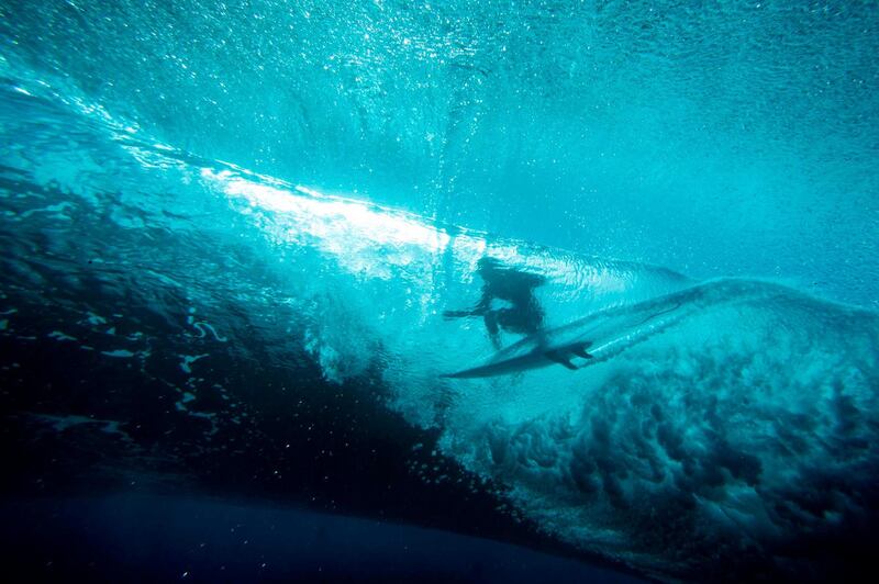 Reef Heazlewood from Australia rides in the "tube", shot from an underwater perspective, at Teahupoo, a reef surfing break in Tahiti.  AFP