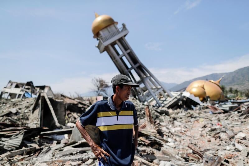 Mohammad Rizal, 57, stands among the rubble at an earthquake devastated area in Balaroa in Palu. EPA