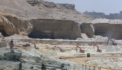 Bulldozers demolish a Mokatam hill to expand the road, as part of a mega project campaign for roads and bridges, in Cairo, Egypt, 14 June  202  EPA / KHALED ELFIQI