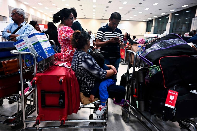 Passengers wait inside the arrival hall at Bandaranaike International Airport in Katunayake on April 22, 2019, after authorities imposed a curfew following eight bomb blasts in the country. A series of eight devastating bomb blasts ripped through high-end hotels and churches holding Easter services in Sri Lanka on April 21, killing at least 207 people, including dozens of foreigners. / AFP / Jewel SAMAD
