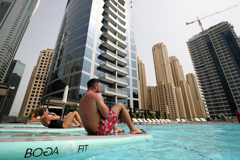 Dubai, United Arab Emirates - July 28, 2018: Debbie and Will Jones take part in FloatUAE which is an exercise class performed on a float in the water. Saturday, July 28th, 2018 in The Marina, Dubai. Chris Whiteoak / The National