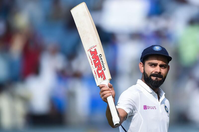 India's cricket team captain Virat Kohli rises his bat as he leaves the field after declearing their first innings during the second day of the second Test cricket match between India and South Africa at Maharashtra Cricket Association Stadium in Pune on October 11, 2019. IMAGE RESTRICTED TO EDITORIAL USE - STRICTLY NO COMMERCIAL USE
 / AFP / Punit PARANJPE / IMAGE RESTRICTED TO EDITORIAL USE - STRICTLY NO COMMERCIAL USE
