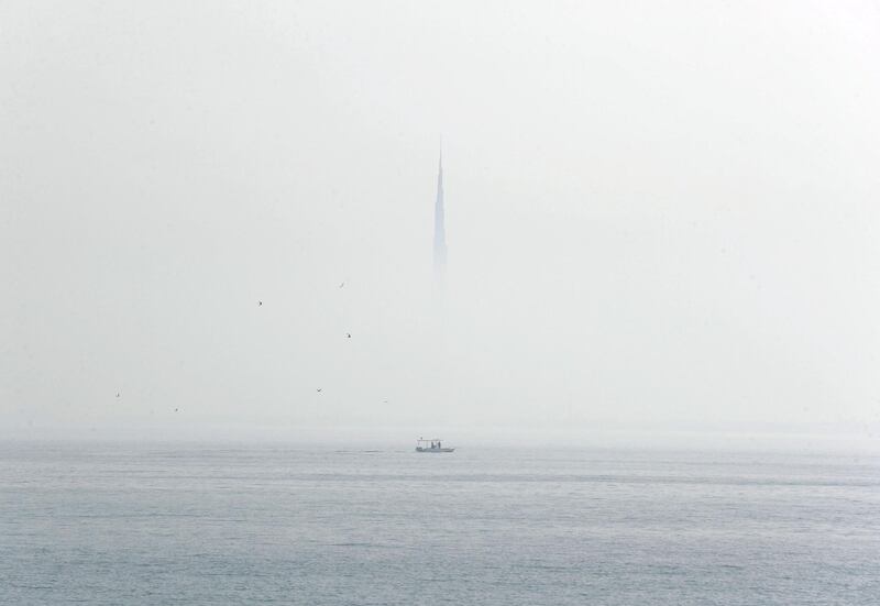 Dubai, United Arab Emirates - Reporter: N/A: Weather. Fog and mist cover the Burj Khalifa as a boat goes passed. Wednesday, April 8th, 2020. Dubai. Chris Whiteoak / The National
