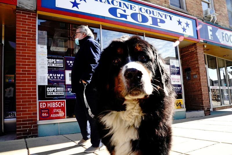 Larry the Conservative Dog and his owner, investment advisor Tom Bode, are seen outside the Racine County Republican Party Office in Racine, Wisconsin. Reuters
