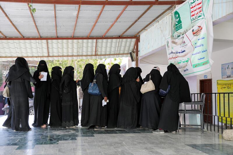 Women stand in line to get food vouchers at a World Food Programme food aid distribution center in Sanaa, Yemen February 11, 2020. REUTERS/Khaled Abdullah