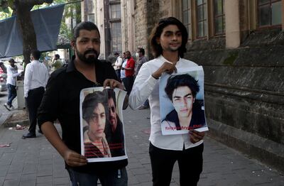 Fans of Bollywood actor Shah Rukh Khan hold posters calling for the  release of his son Aryan Khan outside Bombay High Court in Mumbai, India. AP Photo
