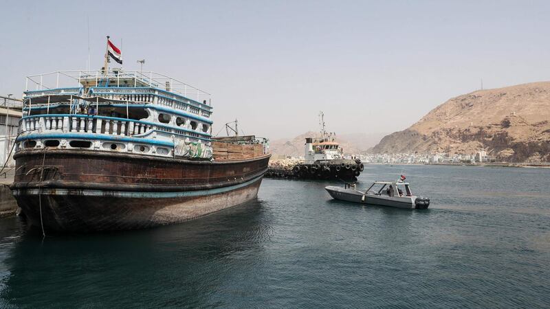A Yemeni military patrol boat cruising past ships moored at the dock in Mukalla. AFP